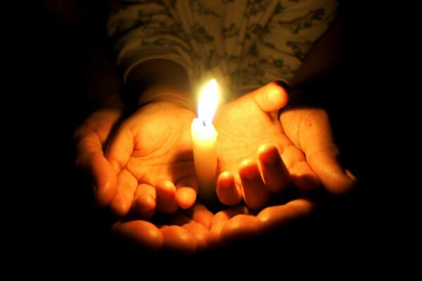 hands holding candle